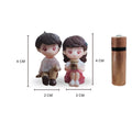 Go Hooked romantic couple figurines, boy in pink shirt and brown pants, girl in pink dress holding tea cup. Resin, 4cm tall.