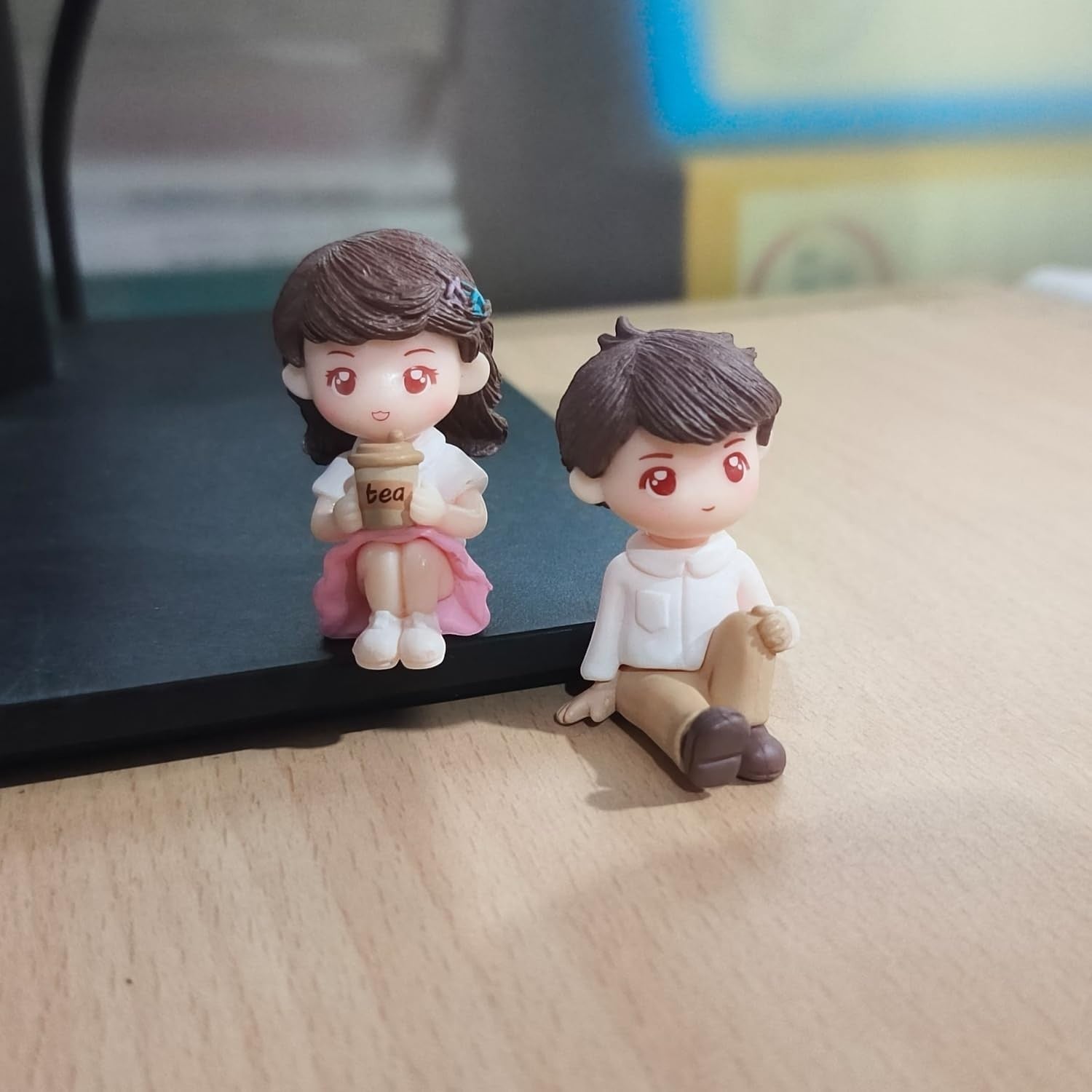 Go Hooked resin couple figurines: girl in pink dress holding tea, boy in white shirt and tan pants. Romantic decor.