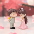 GoHooked resin couple figurines in proposal pose, boy with flowers, girl in pink dress. Romantic decor.