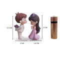 Go Hooked resin couple figurines in proposal pose, boy in white suit with flowers, girl in pink dress. Perfect for cake decor.