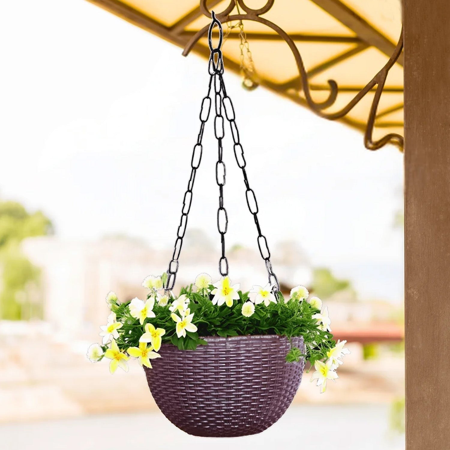GoHooked dark brown plastic hanging planter with a textured weave pattern and black chain, holding yellow flowers.