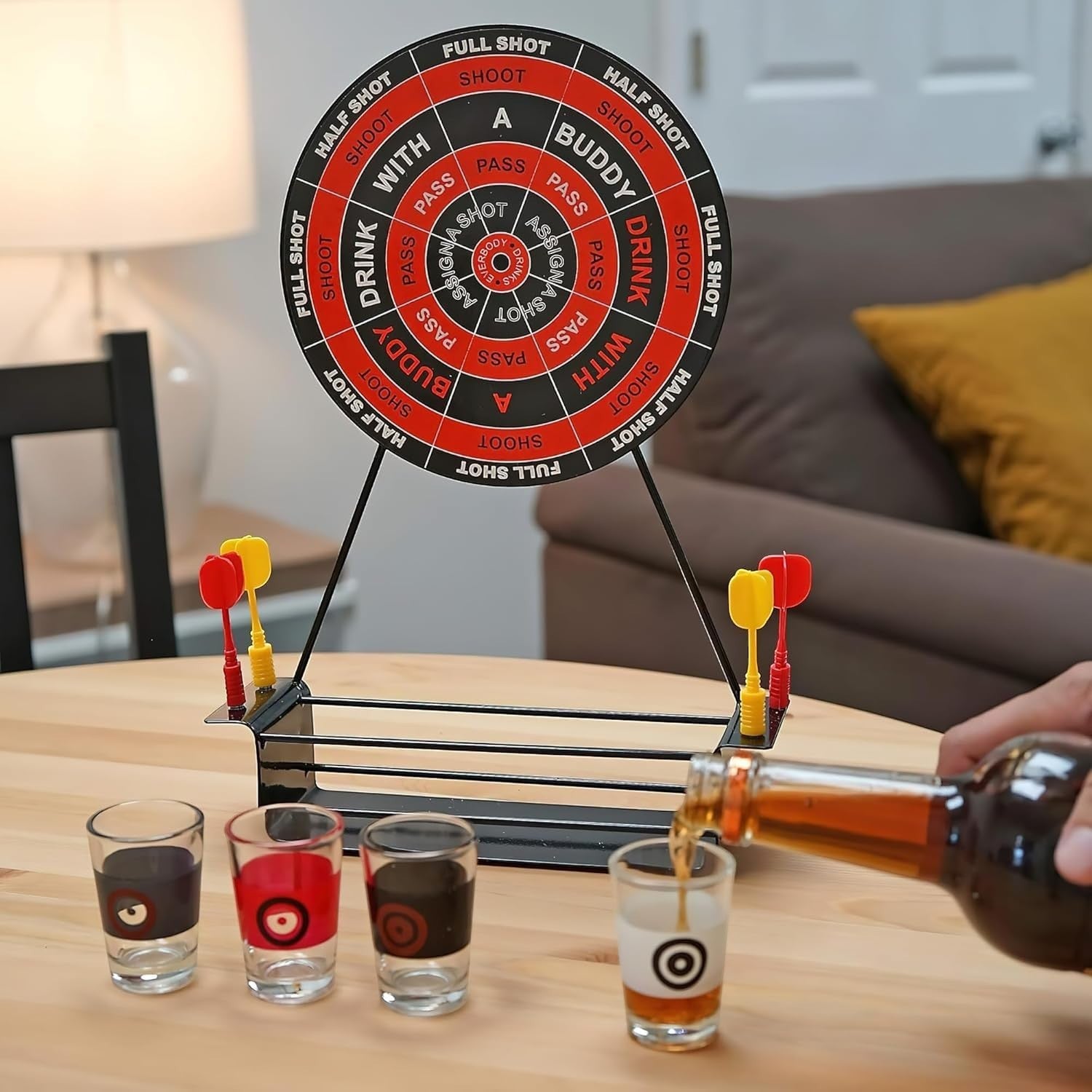 GoHooked dartboard drinking game with 4 shot glasses and 4 darts on a wooden table, perfect for parties.