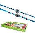 GoHooked blue and silver designer Rakhis with evil eye and hamsa charms, beaded with blue and clear crystals. Includes roli chawal vials and storage tray.