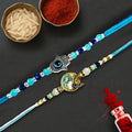 GoHooked set of 2 designer rakhis with blue beads, evil eye charm, and sun deity pendant. Includes roli, chawal, and tray.