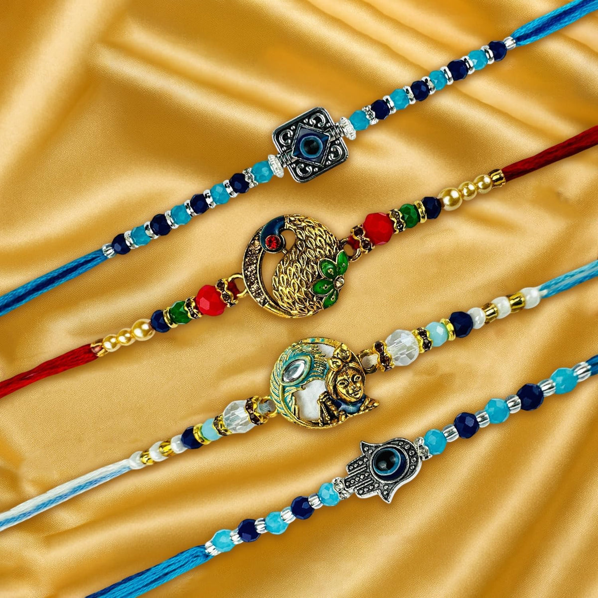 GoHooked set of 4 designer rakhis with pearl beads, peacock, Krishna, and hamsa hand charms. Multicolor.