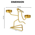 Go Hooked matte gold metal tealight candle holder with dual tray in a running figurine design on a triangular base.
