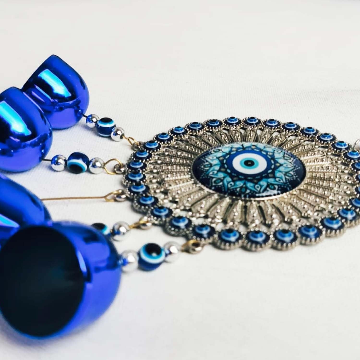GoHooked blue glass evil eye wind chime with 5 bells and tassel, metal alloy medallion for home protection.