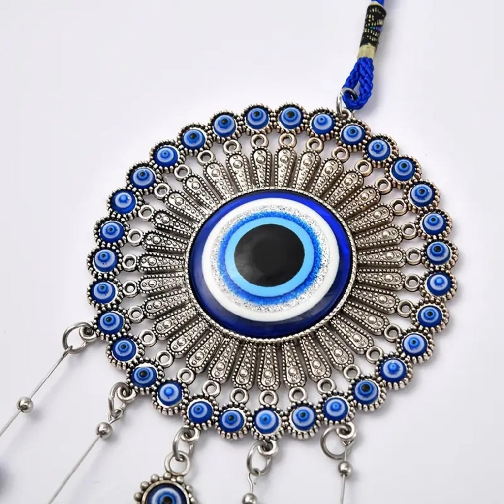 GoHooked blue glass evil eye wind chime with silver metal accents and tassel. Believed to ward off negative energy.
