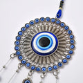 GoHooked blue glass evil eye wind chime with silver metal accents and tassel. Believed to ward off negative energy.