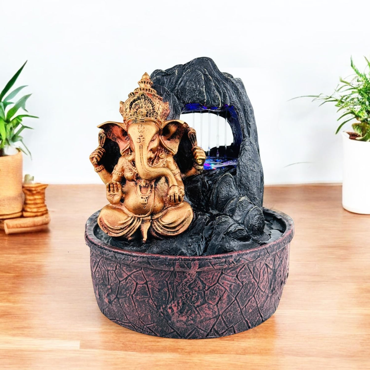 GoHooked Lord Ganesha polyresin tabletop fountain with LED lights and adjustable water flow, bronze finish.