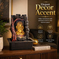Go Hooked multicolour polyresin Lord Ganesha tabletop water fountain with LED light and pump, featuring a stone texture and tree accent.