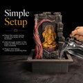 GoHooked multicolour polyresin tabletop water fountain with a golden Ganesha idol, LED lights, and a stone texture finish.