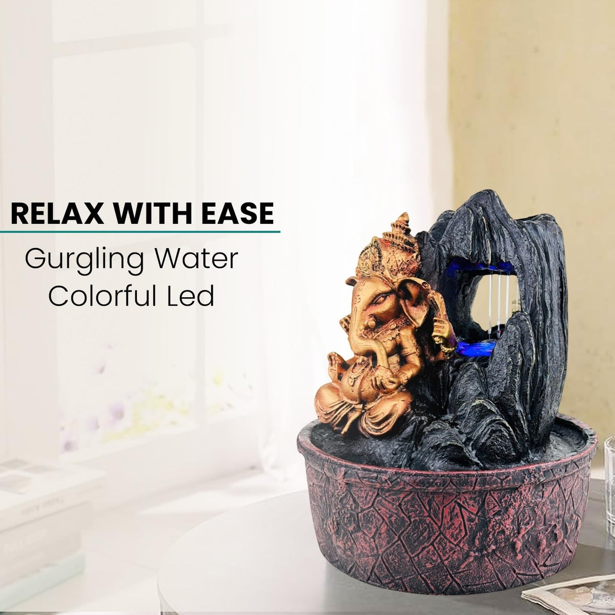 GoHooked Lord Ganesha polyresin tabletop fountain with LED lights and adjustable water flow, bronze and black.