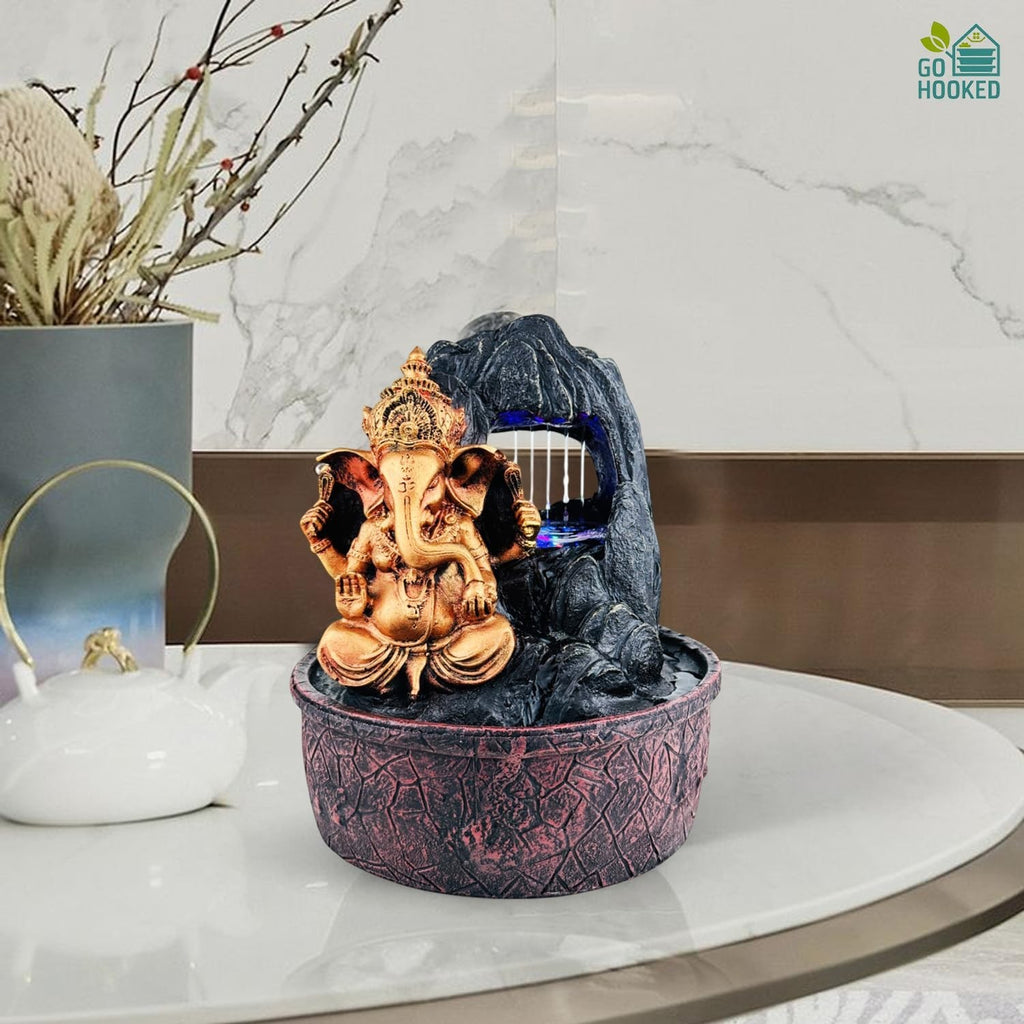 Go Hooked Lord Ganesha polyresin tabletop fountain with LED lights and adjustable water flow, bronze and black.
