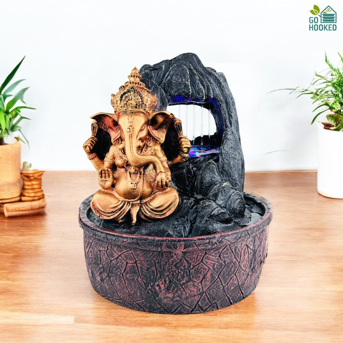 GoHooked bronze Lord Ganesha polyresin tabletop fountain with LED lights and adjustable water flow, featuring a rock waterfall.