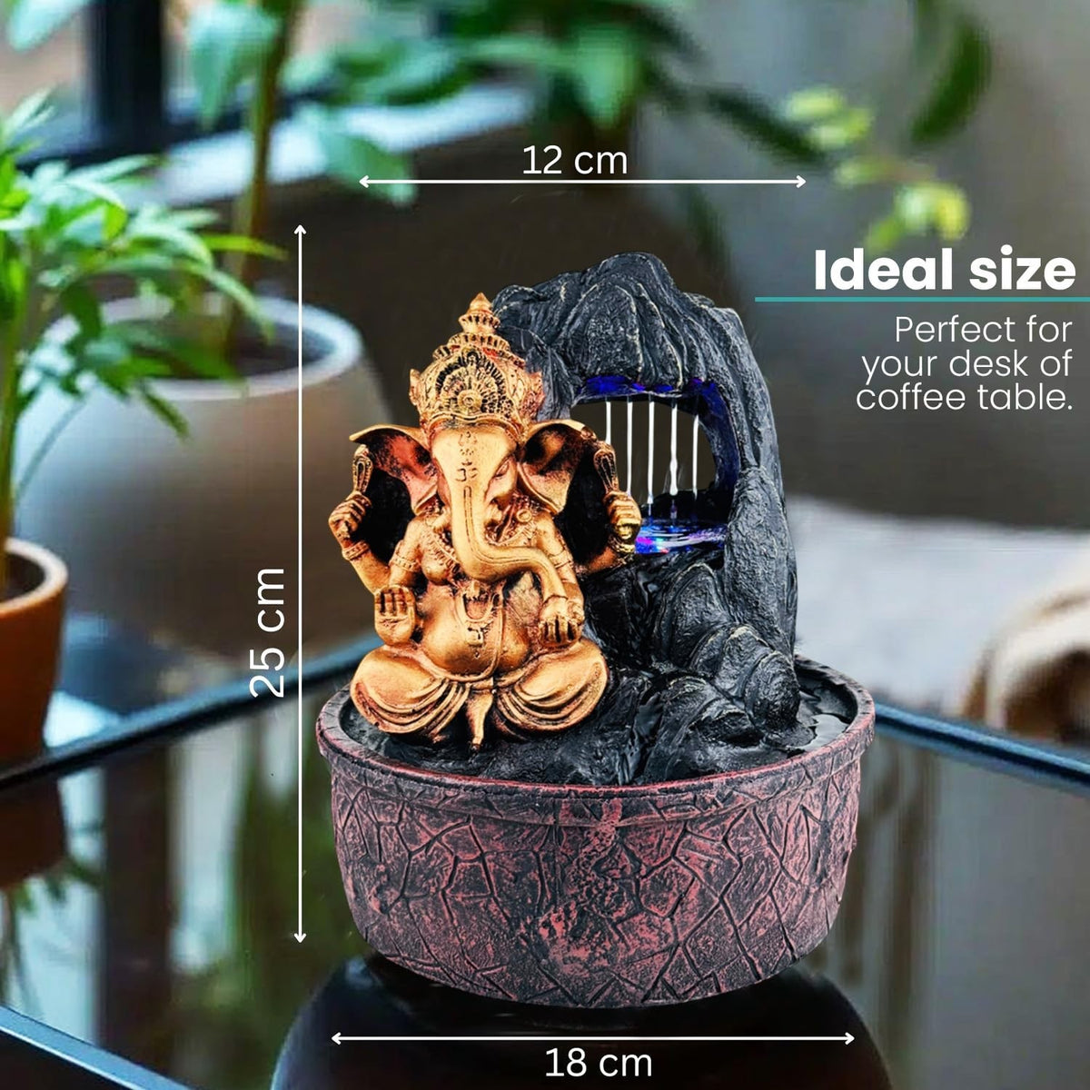 GoHooked Lord Ganesha polyresin tabletop fountain with LED lights and adjustable water flow. Golden Ganesha statue with black rock waterfall.