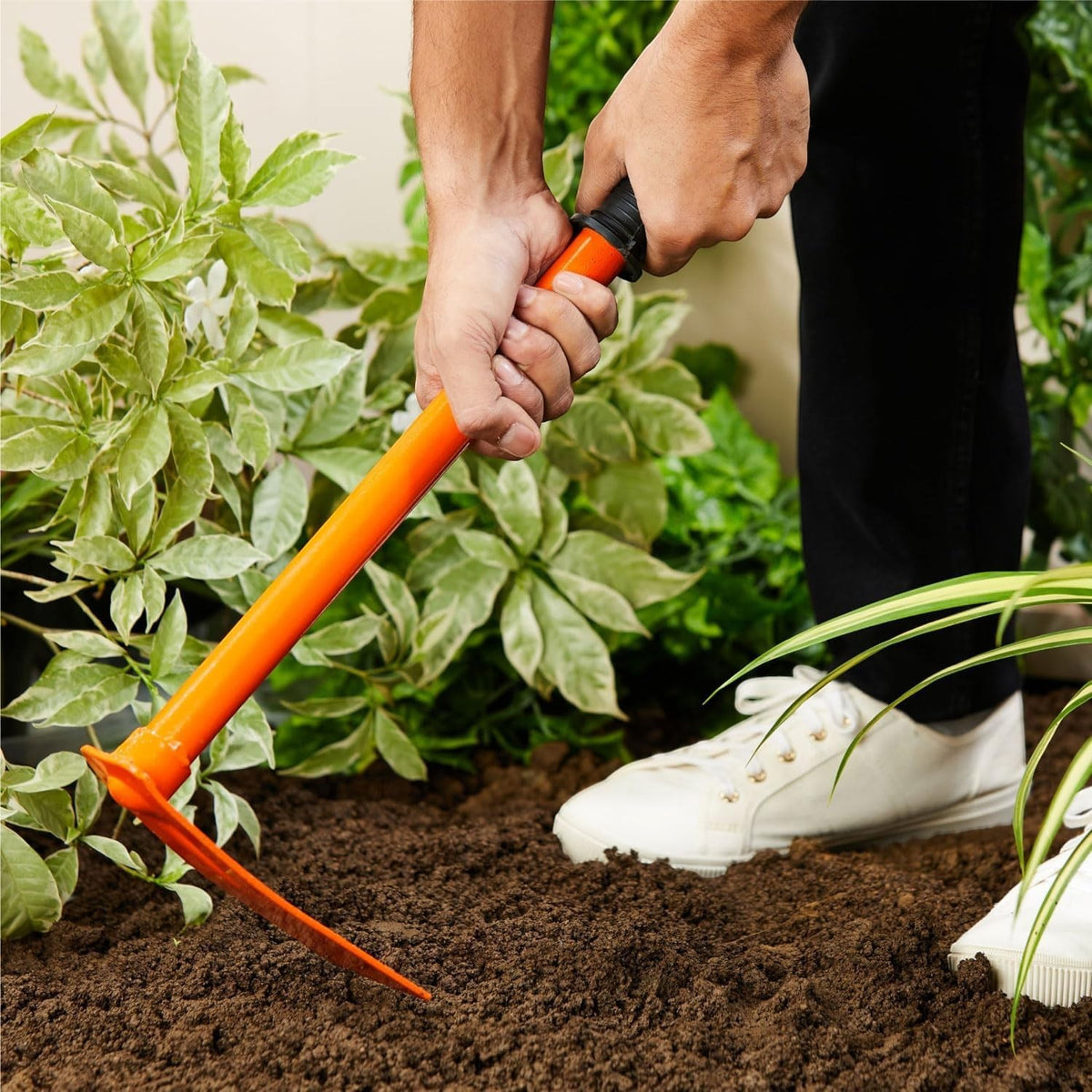 GoHooked orange steel garden pickaxe and hand hoe with prongs for tilling and weeding in soil.