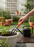 Go Hooked gardening fork with orange handle in use, next to a black watering can.