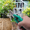 Go Hooked green ergonomic hand pruner with steel blades, ideal for gardening and trimming plants. Features a safety latch.