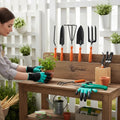 GoHooked 7-piece gardening tool set with orange handles, including gloves, pruners, cultivator, fork, shovel, trowel, and weeder.