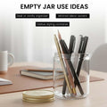 GoHooked clear glass jar with gold lid, holding pens and pencils on a desk. Ideal for desk organization.