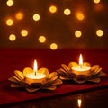 GoHooked Matte gold lotus-shaped metal tealight candle holders with lit candles, set of 2.