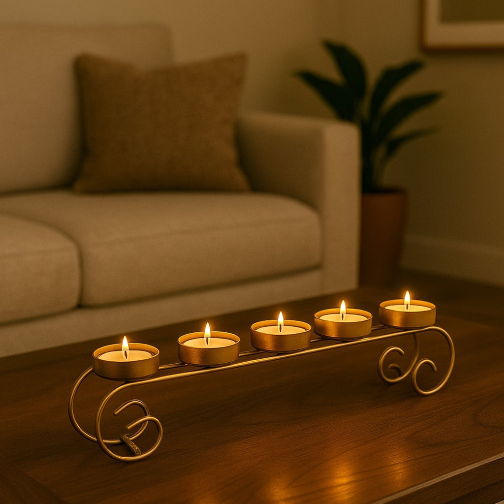 GoHooked gold metal 5-tealight candle holder with scroll base on a wooden table