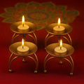 GoHooked gold metal pedestal tealight candle holders with a tripod base, set of 4, ideal for Diwali decor.