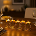 GoHooked gold metal tealight candle holder with five circular rings and trays, 38cm, for table decor.