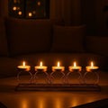 GoHooked gold metal circular ring tealight candle holder with 5 trays on a table, lit candles