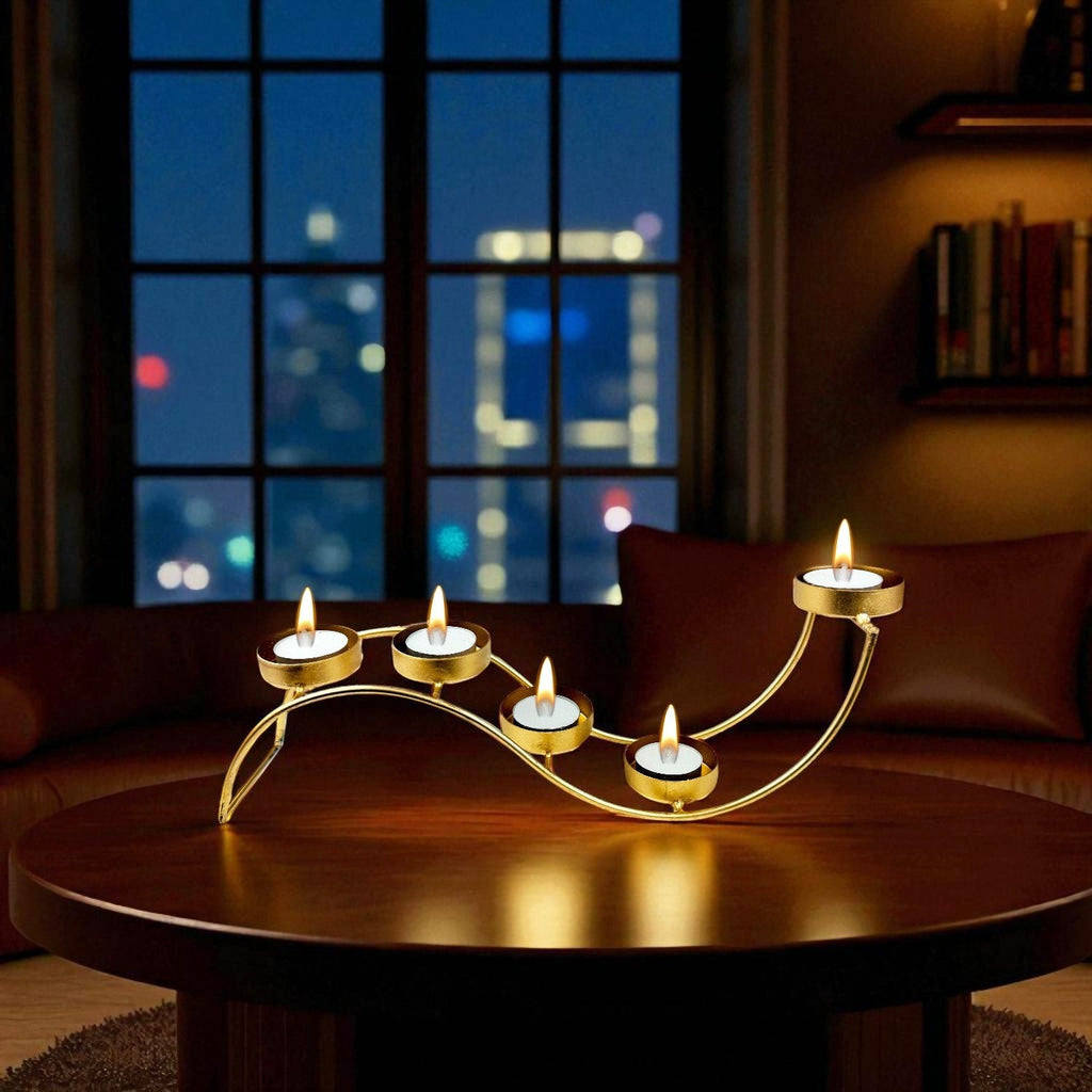 Go Hooked gold metal wave tealight candle holder with 5 trays on a wooden table.