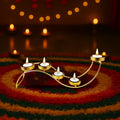 GoHooked gold metal wave tealight candle holder with 5 trays on a colorful rug, 38cm