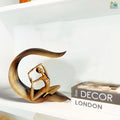 GoHooked gold polyresin meditating woman yoga statue in elegant pose on a decorative leaf base.