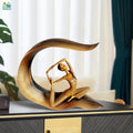GoHooked gold polyresin meditating yoga lady statue in elegant pose on decorative leaf base.