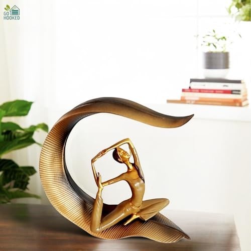 GoHooked gold polyresin meditating yoga lady statue in a graceful pose with a curved leaf-like base.