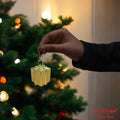 Go Hooked golden gift box Christmas ornament with glitter accents, perfect for festive decor.