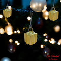 GoHooked golden gift box Christmas ornaments with glitter accents, perfect for festive decor.