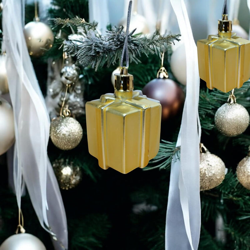 GoHooked golden gift box shaped Christmas ornaments with glitter accents, hanging on a decorated tree.