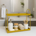 GoHooked golden metal 2-tier standing rack organizer holding soap, cotton swabs, rolled towel, and toothbrushes in a bathroom.