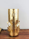 GoHooked golden metal bedside table lamp with butterfly cutouts and embossed butterfly on top. Features off-white shade.