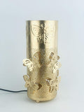 Go Hooked golden metal table lamp with butterfly cutouts and embossed butterfly design. Features off-white shade and touch switch.