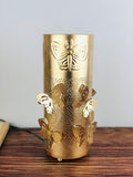 GoHooked golden metal bedside table lamp with butterfly cutouts and off-white shade. Touch activated.