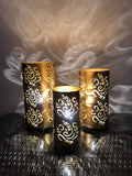 GoHooked set of 3 golden metal table lamps with intricate Ganesha cutouts, casting decorative shadows.