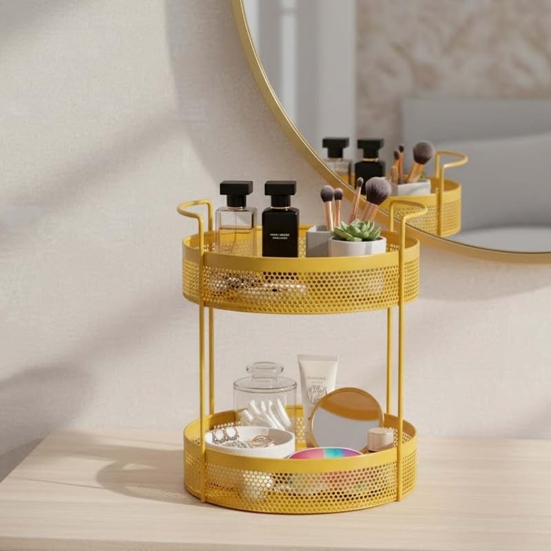 Go Hooked golden metal 2-tier round storage basket with mesh design, holding perfumes, makeup brushes, and cosmetics.