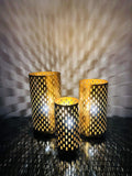Go Hooked set of 3 golden metal table lamps with cut-out patterns casting shadows. Art Deco style.