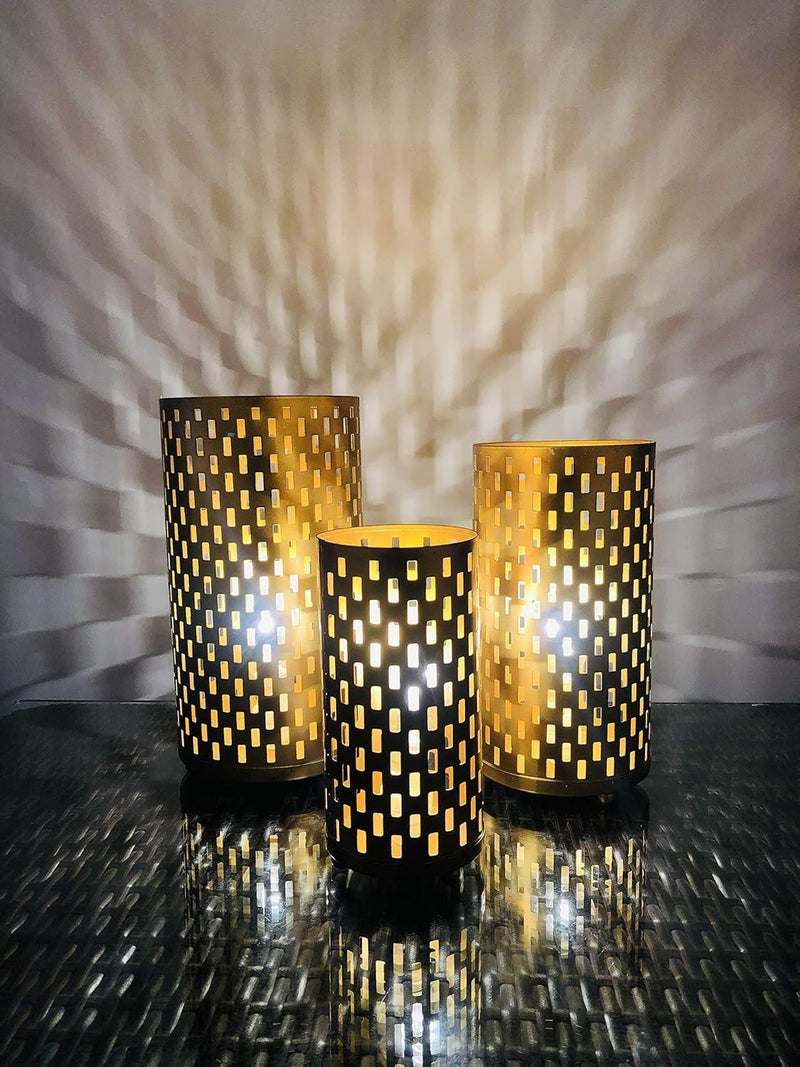 Go Hooked set of 3 golden metal table lamps with cutout patterns casting decorative shadows. Art Deco style.