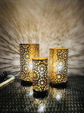 Set of 3 Go Hooked golden metal decorative table lamps with intricate star patterns, casting beautiful shadows.