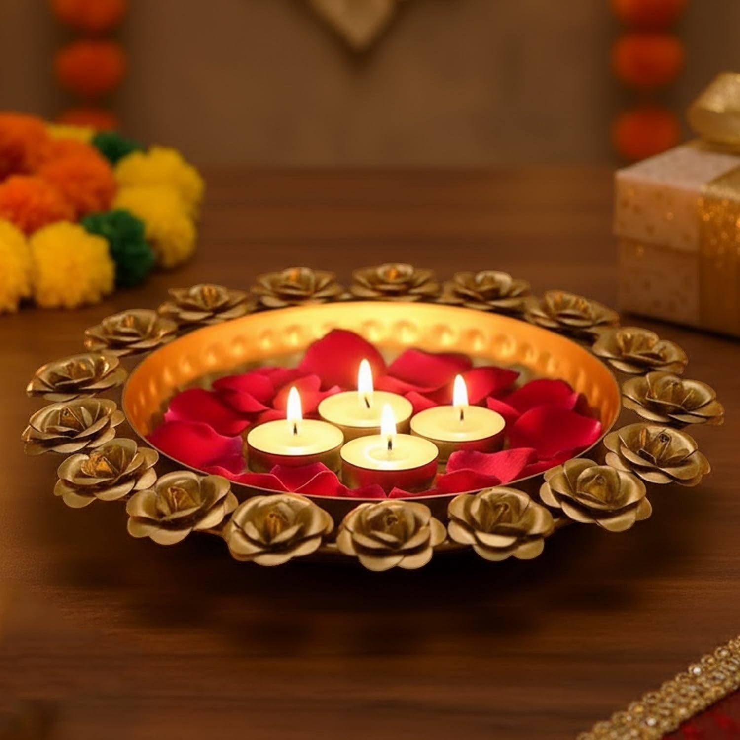 GoHooked golden metal urli bowl with rose border, filled with red rose petals and floating candles. 29 cm.