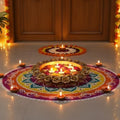 GoHooked handcrafted golden metal urli bowl with rose border, filled with floating candles and petals, part of a Diwali rangoli.