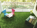 GoHooked green artificial grass carpet mat, 35mm thick, for balconies and gardens. Features two small chairs and a table.